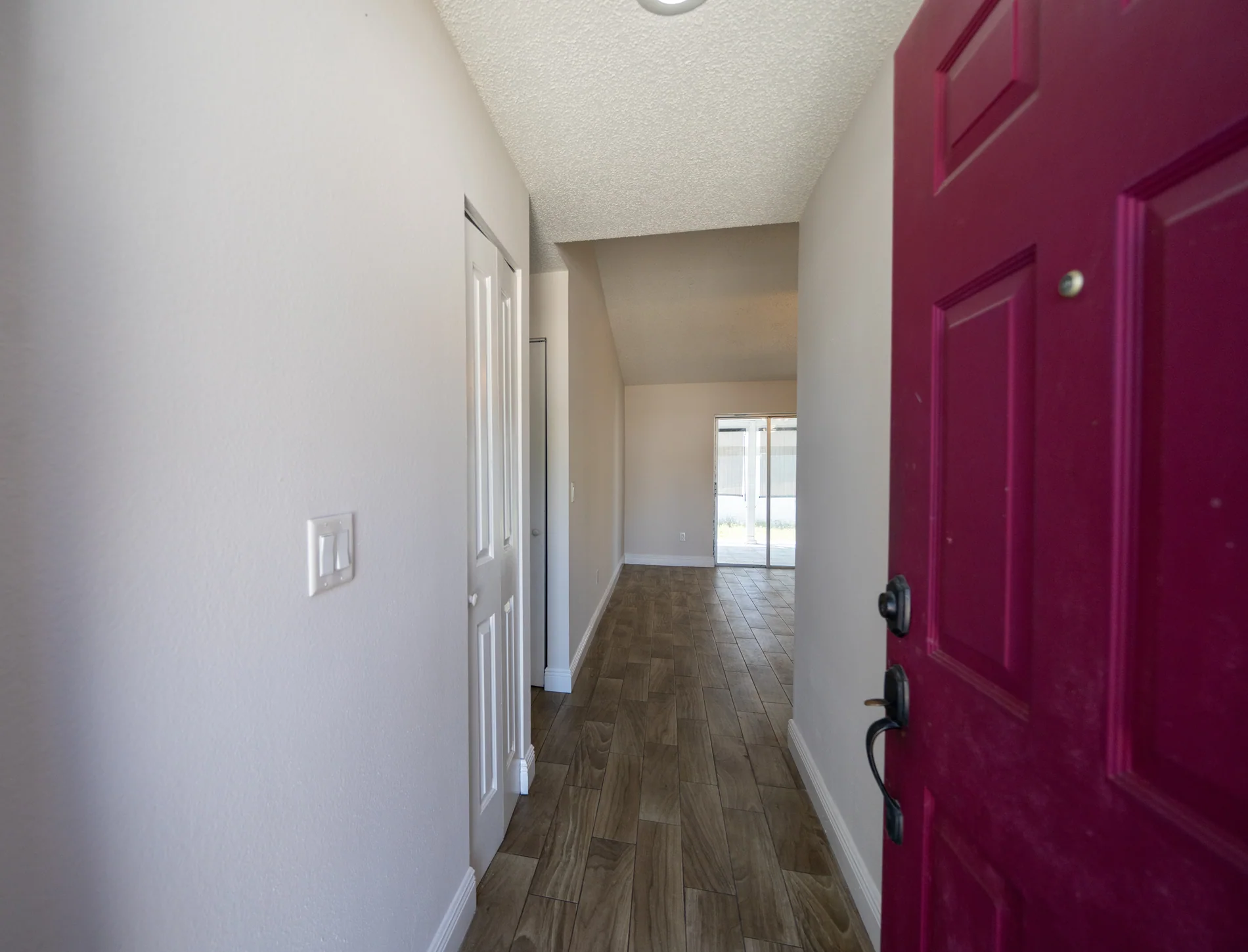 Residential entry hall with a red front door