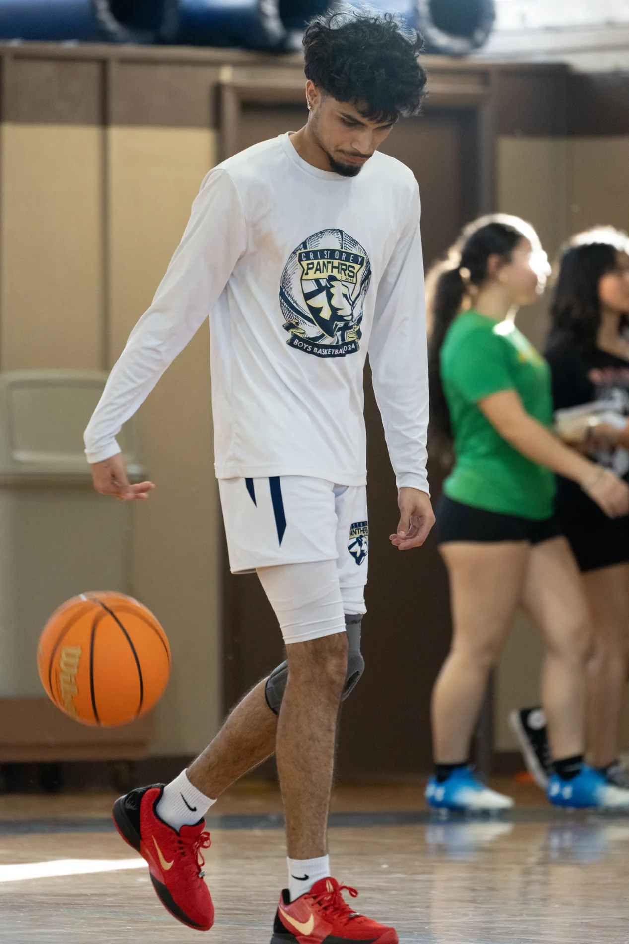 Basketball player moving with the ball during warmups