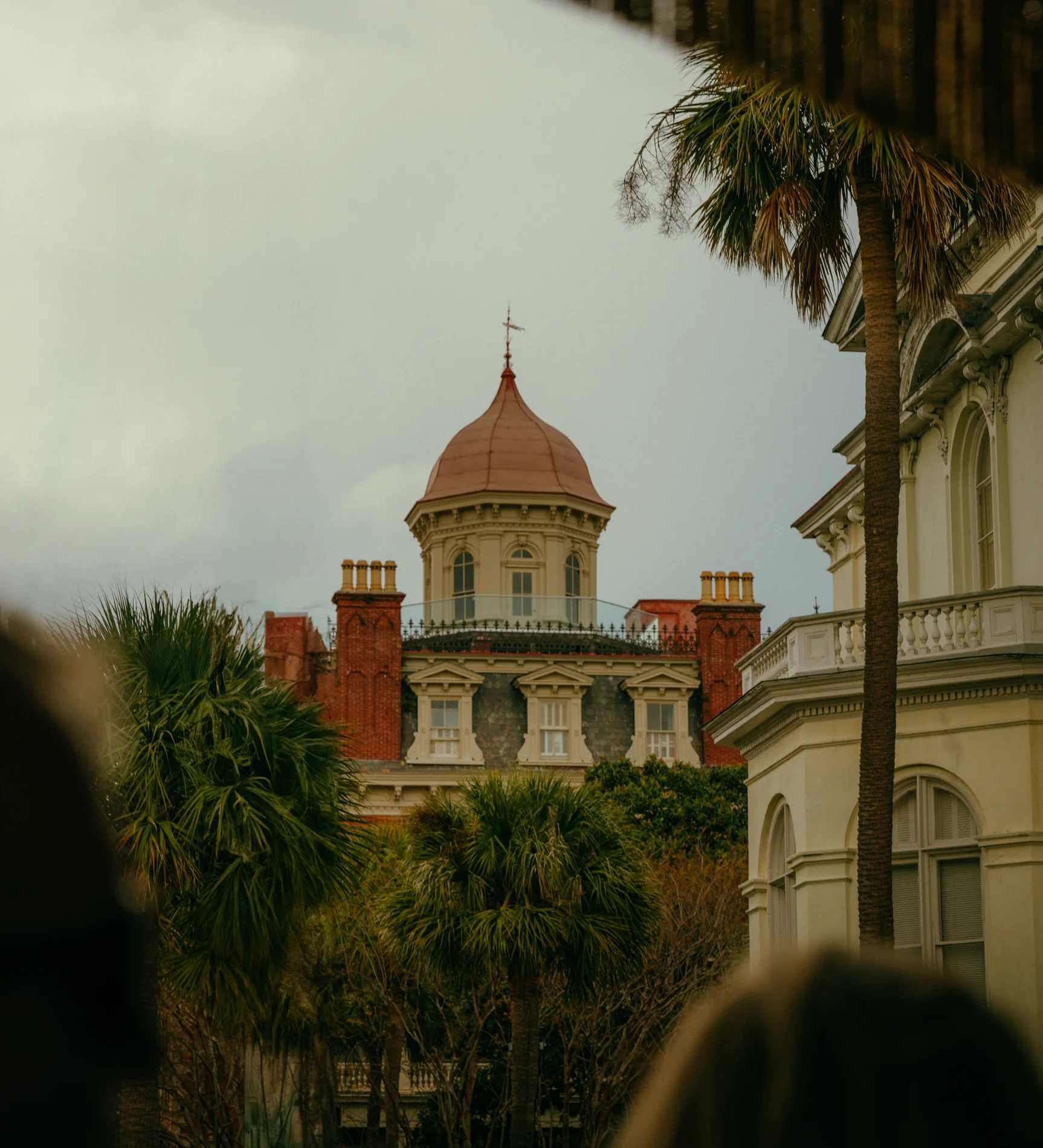 Historic cupola framed between palm trees