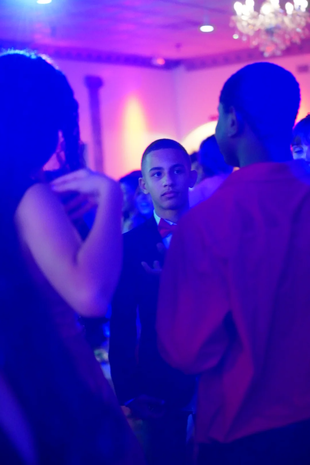 Candid event moment under blue and magenta light