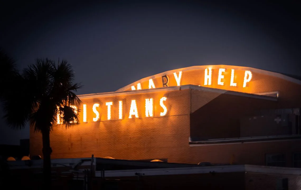 Illuminated building sign against the night sky