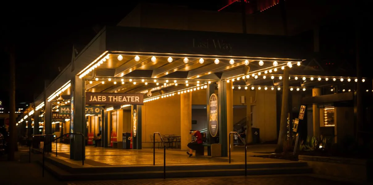 Historic theater glowing beneath string lights at night