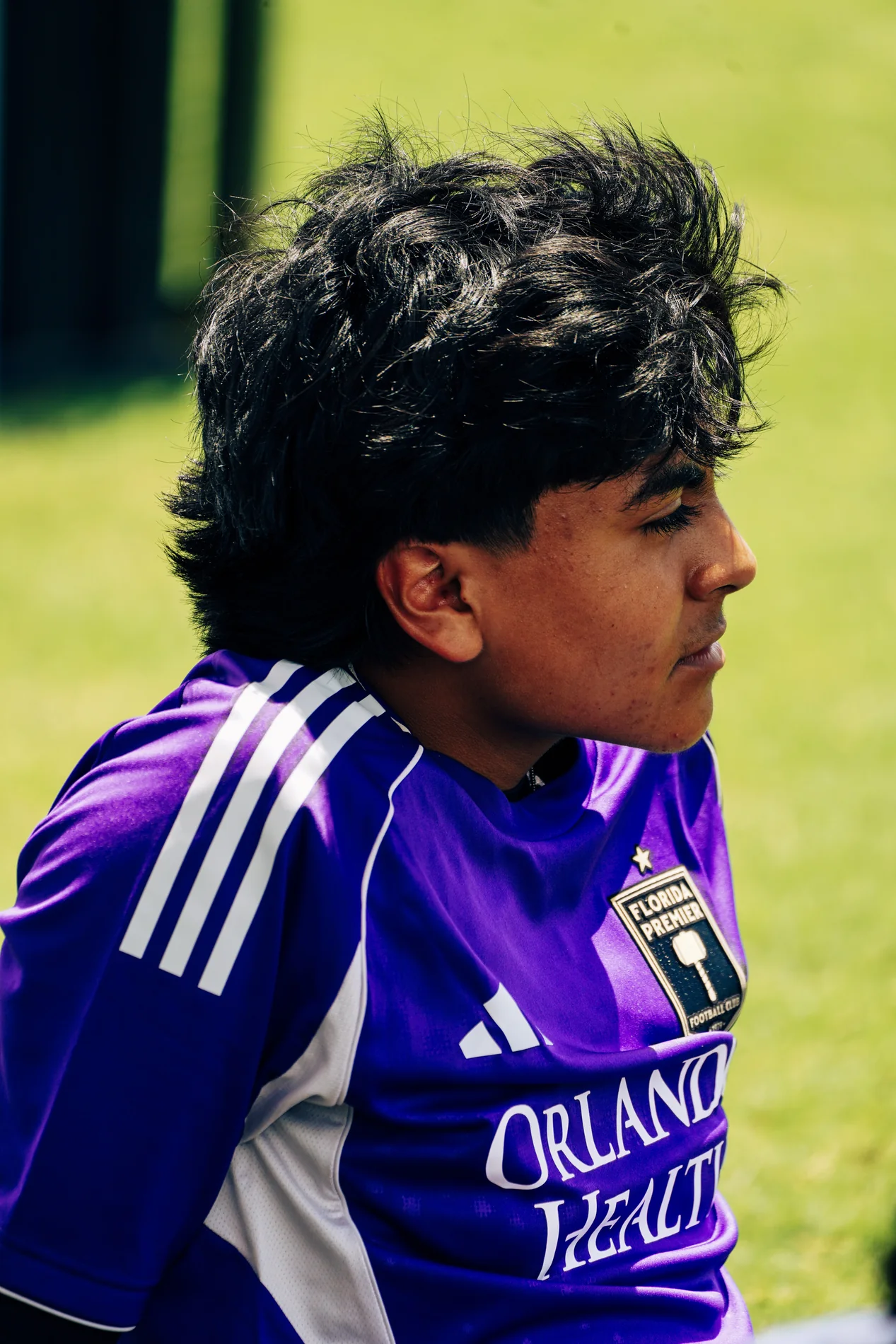 Soccer player in a purple jersey at the sideline