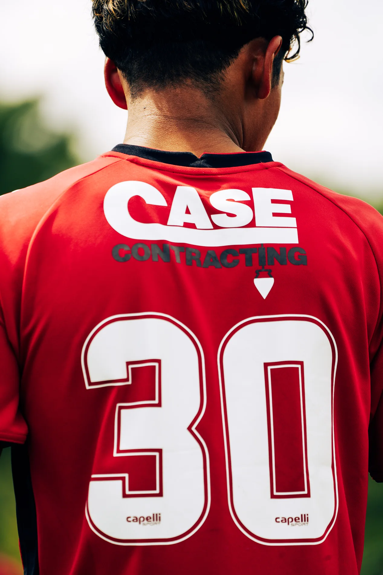 Back of a red number 30 soccer jersey