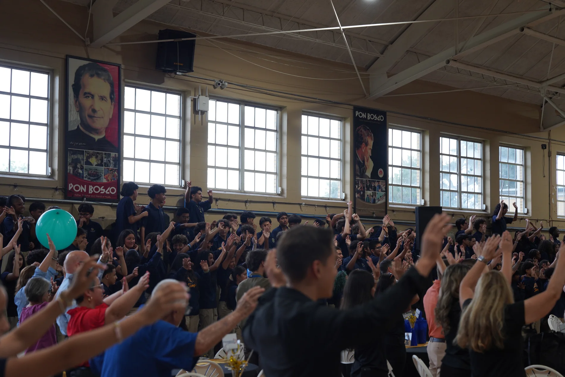 School crowd filling the gym bleachers